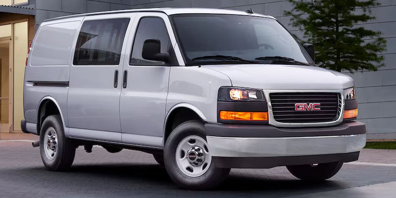 White GMC savana cargo van parked outside on the parking lot