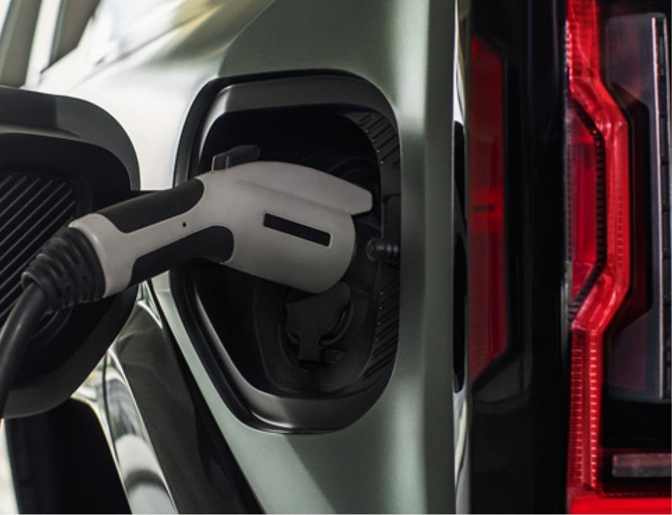 Close up of charging port with charger plugged in on a GMC Hummer EV SUV - Dow Lewis Motors in YUBA CITY CA